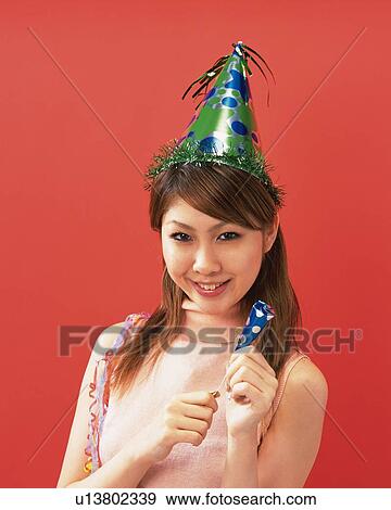Stock Photo - Young Woman Having a Party, Front View, Looking at Camera. Fotosearch