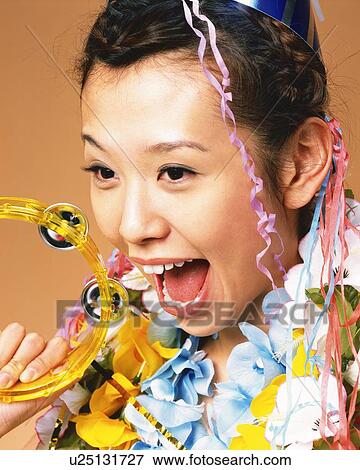 Stock Photo - Young Woman Laughing at Party, Side View. Fotosearch