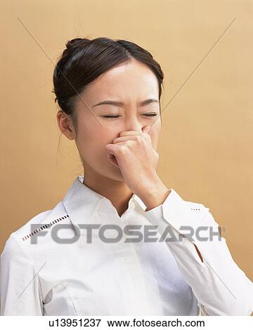 Young Woman Pinching Nose, Side View View Large Photo Image Stock Photo - Young Woman Pinching Nose, Side View. Fotosearch