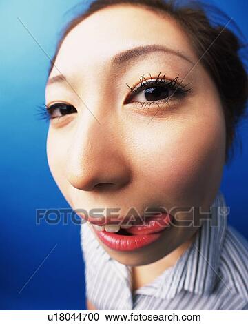 Young Woman Putting Her Tongue Out, High Angle View, Fish-Eye, Looking at Camera View Large Photo Image Stock Image - Young Woman Putting Her Tongue Out, High Angle View, Fish-Eye, Looking at Camera. Fotosearch