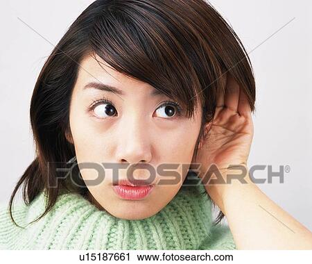 Stock Image - Young Woman Trying To Hear Something, Front View. Fotosearch