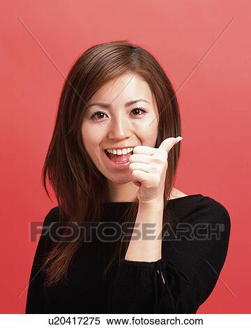 Young Woman with thumb Up, Front View, Looking at Camera View Large Photo Image Stock Photography - Young Woman with thumb Up, Front View, Looking at Camera. Fotosearch