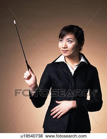 Businesswoman at presentation and explaining with pointer, Studio, Portrait View Large Photo Image Stock Photo - Businesswoman at presentation and explaining with pointer, Studio, Portrait. Fotosearch