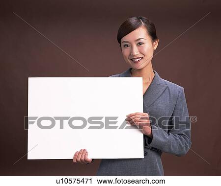 Businesswoman holding blank whtie cardboard, Studio, Portrait View Large Photo Image Stock Image - Businesswoman holding blank whtie cardboard, Studio, Portrait. Fotosearch