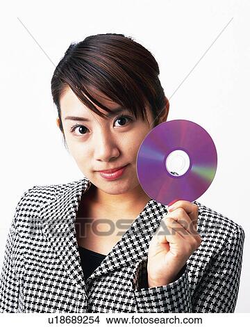 Picture - Businesswoman holding CD in hand, Studio, Portrait. Fotosearch