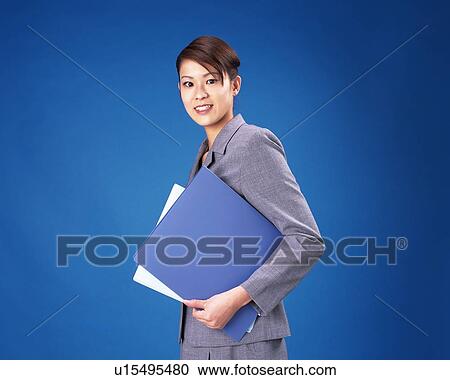 Businesswoman looking at camera and holding documents, Studio, Portrait View Large Photo Image Stock Image - Businesswoman looking at camera and holding documents, Studio, Portrait. Fotosearch