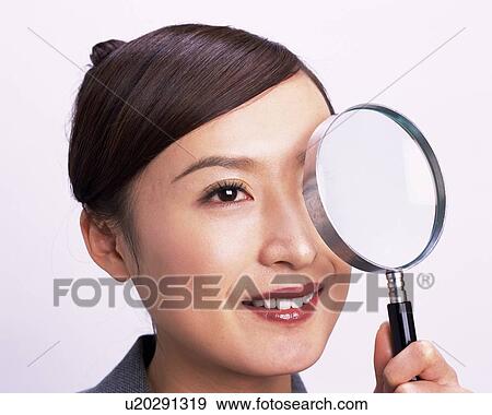 Businesswoman looking at something with magnifying glass, Close Up, Studio, Portrait View Large Photo Image Stock Photo - Businesswoman looking at something with magnifying glass, Close Up, Studio, Portrait. Fotosearch