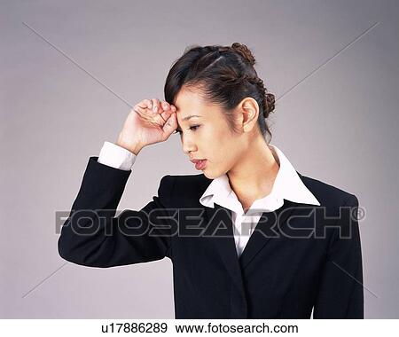 Stock Photo - Businesswoman not feeling well, Studio, Portrait. Fotosearch