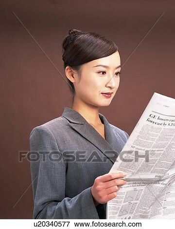 Businesswoman reading news paper, Studio, Portrait View Large Photo Image Stock Photo - Businesswoman reading news paper, Studio, Portrait. Fotosearch