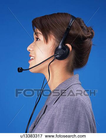 Businesswoman talking with headset, Side View, Studio, Portrait View Large Photo Image Stock Photo - Businesswoman talking with headset, Side View, Studio, Portrait. Fotosearch