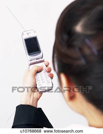 Businesswoman using mobile phone, Rear View, Studio, Portrait View Large Photo Image Stock Photo - Businesswoman using mobile phone, Rear View, Studio, Portrait. Fotosearch