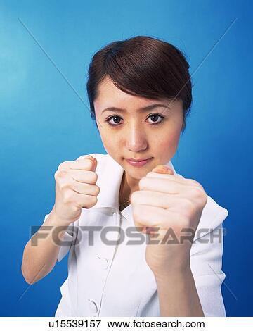 Stock Photo - Businesswoman with fighting pose, Studio, Portrait. Fotosearch
