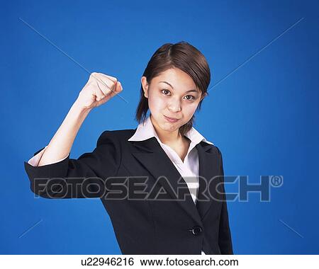Stock Photograph - Businesswoman with victory pose, Studio, Portrait. Fotosearch
