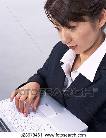 Businesswoman working on laptop computer, Studio, Portrait View Large Photo Image Stock Image - Businesswoman working on laptop computer, Studio, Portrait. Fotosearch