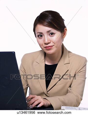 Businesswoman working on laptop computer, Studio, Portrait View Large Photo Image Stock Photograph - Businesswoman working on laptop computer, Studio, Portrait. Fotosearch