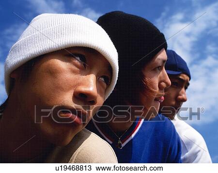 Group of three young adult men close together, Outdoors View Large Photo Image Stock Image - Group of three young adult men close together, Outdoors. Fotosearch
