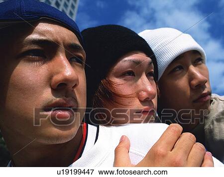 Group of three young adult men close together, Close Up, Outdoors View Large Photo Image Stock Photo - Group of three young adult men close together, Close Up, Outdoors. Fotosearch