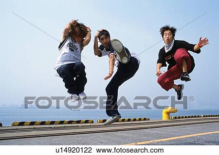 Group of three young adult men jumping, Outdoors View Large Photo Image Stock Image - Group of three young adult men jumping, Outdoors. Fotosearch