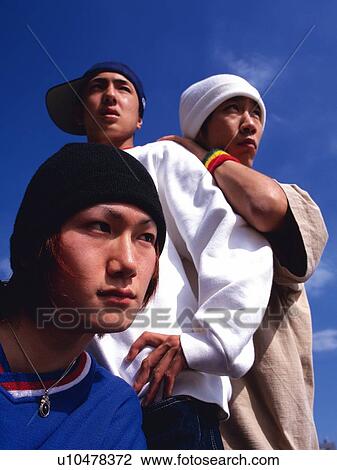 Group of three young adult men poing, Outdoors View Large Photo Image Stock Image - Group of three young adult men poing, Outdoors. Fotosearch