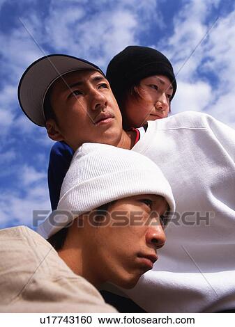 Group of three young adult men poing, Low Angle View, Outdoors View Large Photo Image Stock Image - Group of three young adult men poing, Low Angle View, Outdoors. Fotosearch