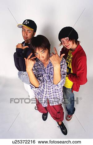 Group of three young adult men poing, Low Angle View, Outdoors View Large Photo Image Stock Photograph - Group of three young adult men poing, Low Angle View, Outdoors. Fotosearch