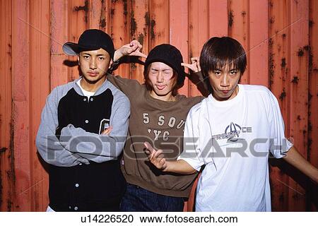 Group of three young adult men posing, Outdoors View Large Photo Image Stock Image - Group of three young adult men posing, Outdoors. Fotosearch