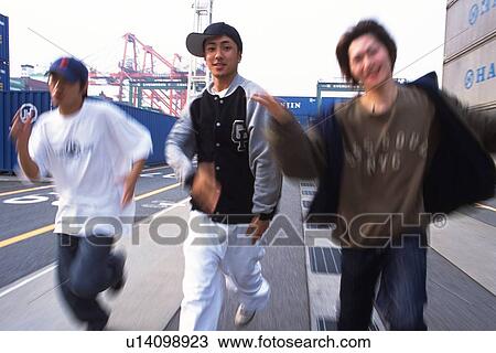 Group of three young adult men running, Outdoors View Large Photo Image Stock Image - Group of three young adult men running, Outdoors. Fotosearch