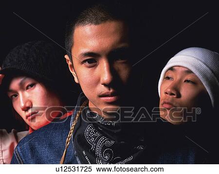 Group of three young adult men staring, Studio View Large Photo Image Stock Photography - Group of three young adult men staring, Studio. Fotosearch