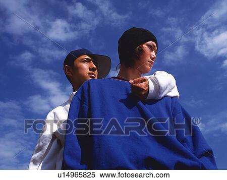 Stock Photography - Group of two young adult men posing, Outdoors. Fotosearch