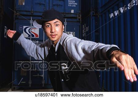 Stock Image - Young adult man dancing, Outdoors, Portraint. Fotosearch