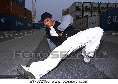 Stock Photograph - Young adult man dancing, Outdoors, Portraint. Fotosearch