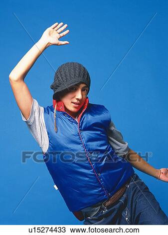 Stock Image - Young adult man dancing, Studio, Portraint. Fotosearch