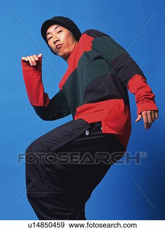 Stock Photo - Young adult man dancing, Studio, Portraint. Fotosearch