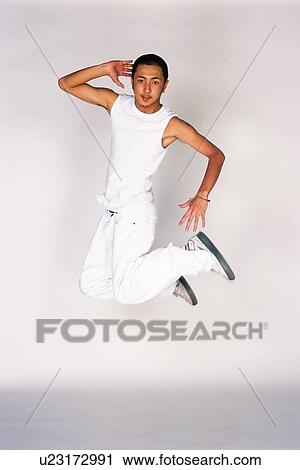 Young adult man jumping, Studio, Portraint View Large Photo Image Stock Image - Young adult man jumping, Studio, Portraint. Fotosearch
