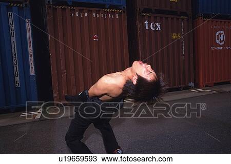 Stock Image - Young adult man shouting, Outdoors, Portrait. Fotosearch