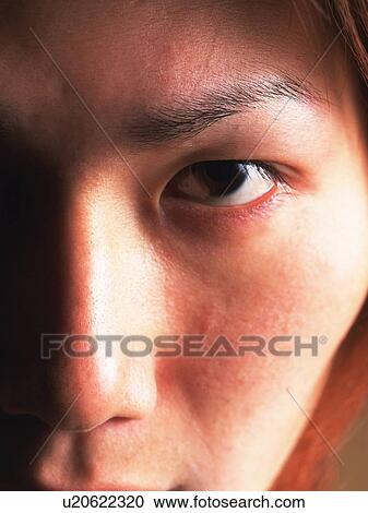 Stock Image - Young adult man staring, Close Up, Portraint. Fotosearch