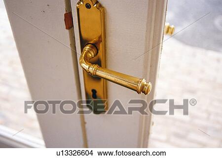 Picture - Closed Up Image of a Golden Door Know on a White Door, High Angle View. Fotosearch