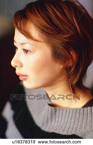Stock Photo - Closed Up Image of a Young Adult Woman, Looking Sideways, Side View, Differential Focus. Fotosearch