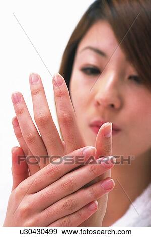 Closed Up Image of a Young Adult Woman Watching Her Hands, Front View, Differential Focus View Large Photo Image Stock Photo - Closed Up Image of a Young Adult Woman Watching Her Hands, Front View, Differential Focus. Fotosearch