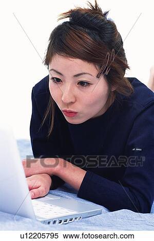 Closed Up Image of a Young Adult Woman Looking at her Laptop Screen With Surprise, Side View View Large Photo Image Stock Photography - Closed Up Image of a Young Adult Woman Looking at her Laptop Screen With Surprise, Side View. Fotosearch