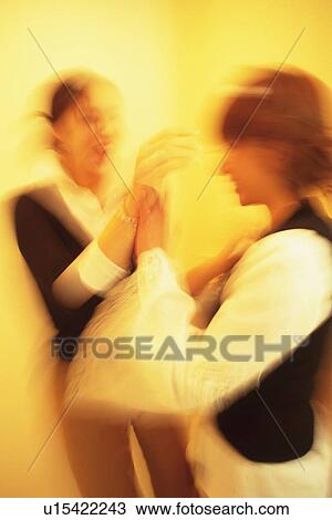 Two Young Adult Women Standing in a Hallway, Holding Each Others Hands, Laughing, Side View, Blurred Motion View Large Photo Image Stock Image - Two Young Adult Women Standing in a Hallway, Holding Each Others Hands, Laughing, Side View, Blurred Motion. Fotosearch