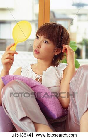 Young Adult Woman Looking at a Little Yellow Mirror, Front View View Large Photo Image Stock Image - Young Adult Woman Looking at a Little Yellow Mirror, Front View. Fotosearch