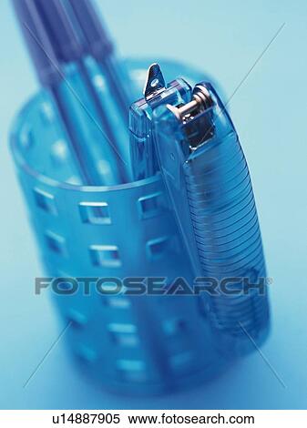 Stock Photography - Blue stapler hung side of penholder. Fotosearch