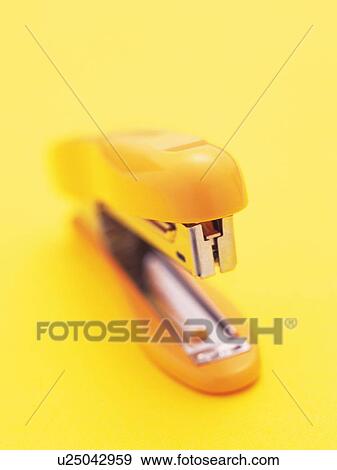 Stock Photo - Close up of yellow stapler. Fotosearch