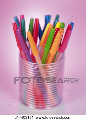 Stock Image - Colored pens in translucent penholder. Fotosearch