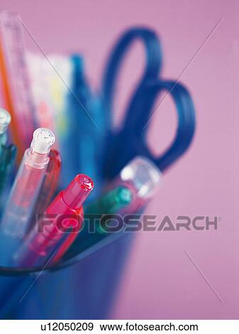 Stock Photo - Colorful stationeries in penholder, close up. Fotosearch