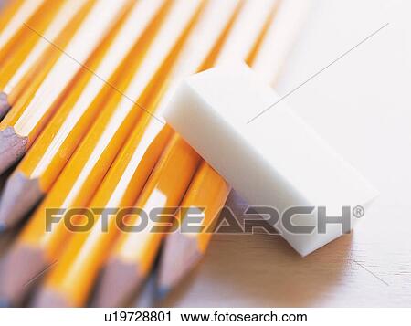 Eraser leaning over pencils laid on desk View Large Photo Image Stock Image - Eraser leaning over pencils laid on desk. Fotosearch