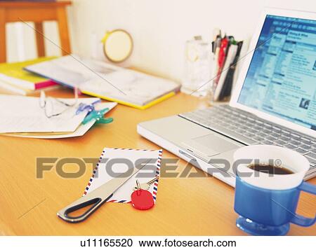 Stock Image - Laptop and stationeries on desk. Fotosearch