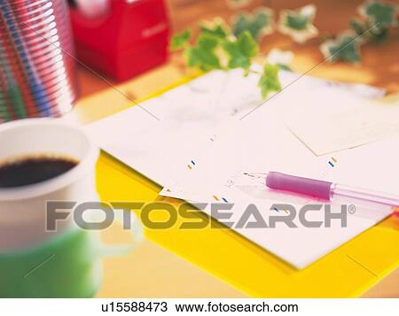 Stock Image - Paper and envelope on yellow desk. Fotosearch