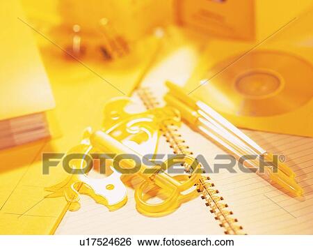 Stock Photograph - Stationeries on table in yellow. Fotosearch